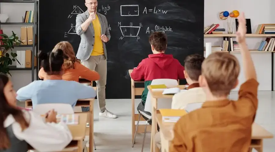 Teacher explaining geometry as students engage in a modern classroom setting.
