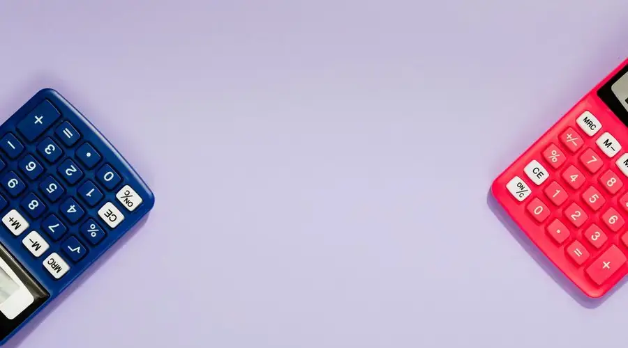 Two colorful calculators on a purple surface, offering ample copy space.