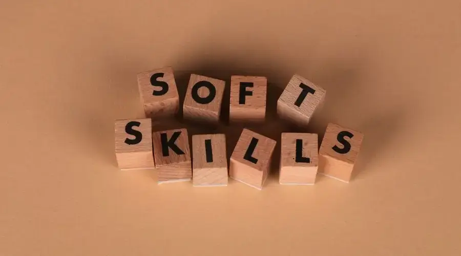 Wooden letter blocks spell out 'Soft Skills', highlighting business and personal development concepts.