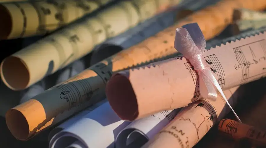 Close-up of rolled music sheets tied with ribbon, perfect for creative and artistic projects.