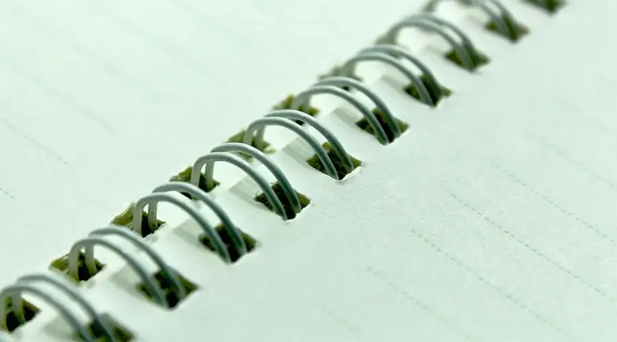 Detailed view of a spiral bound notebook with blank pages ready for writing or drawing.