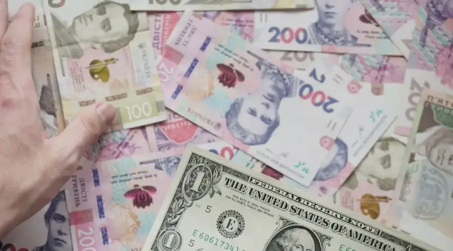 Close-up of various currency notes including US dollar and Ukrainian hryvnia.