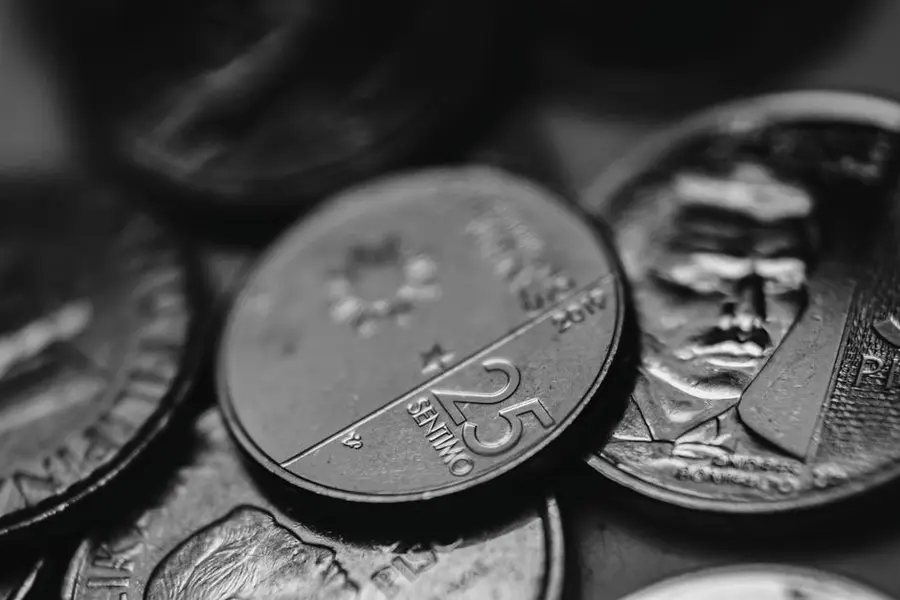 Detailed view of assorted coins highlighting different denominations in monochrome.