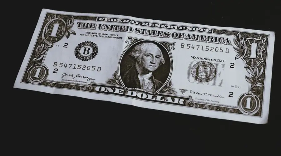 High-resolution image of a one dollar bill with intricate details on a dark background.