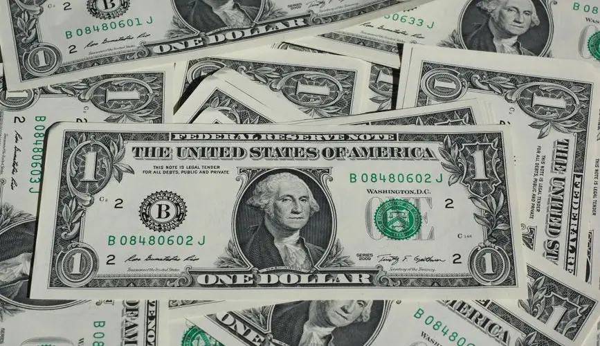 A detailed shot of a pile of U.S. one-dollar bills showcasing currency and finance concepts.