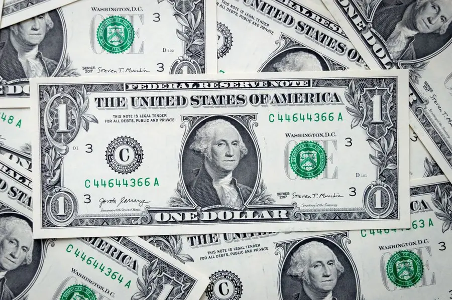 A closeup view of several stacked US dollar bills showcasing currency and financial concepts.