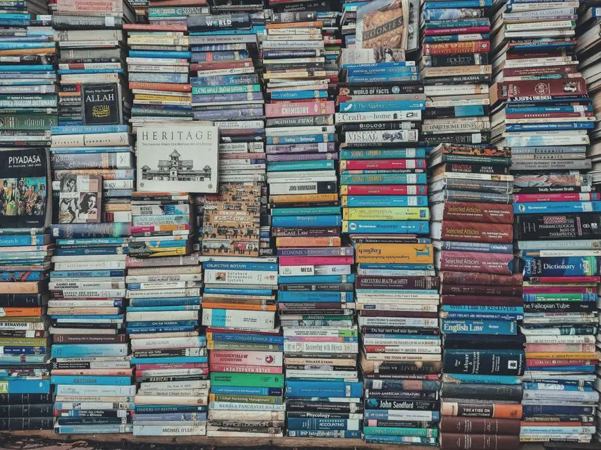 A vibrant collection of stacked books creating a visually arresting pattern in a Dhaka bookstore.