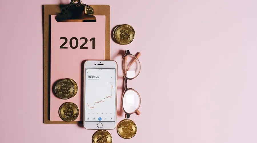 Modern flat lay showing bitcoin coins, smartphone, and clipboard for digital currency finance concept.