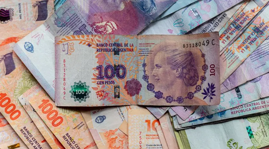 A collection of colorful Argentinian peso bills, featuring diverse denominations and designs.