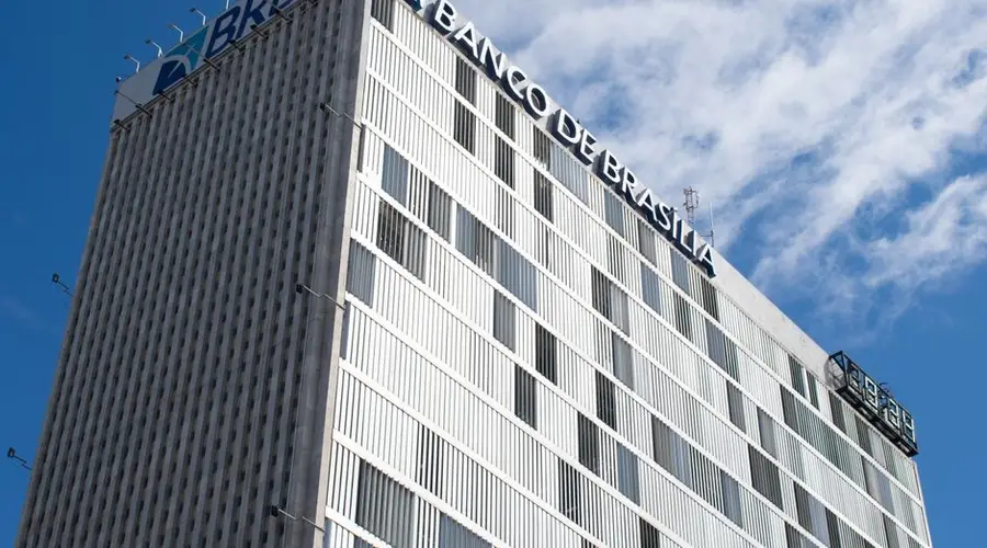 High-rise view of Banco de Brasília against a bright blue sky in Distrito Federal, Brazil.
