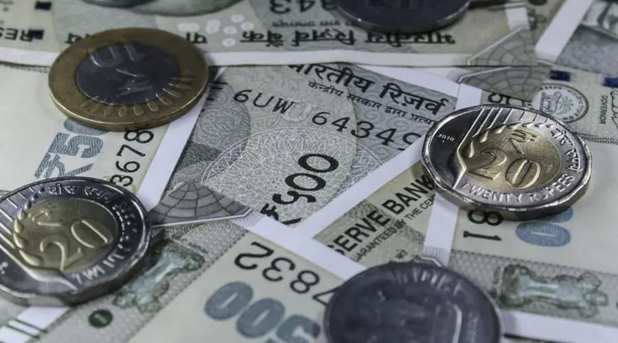Detailed view of Indian rupee banknotes and coins, showcasing currency variety.