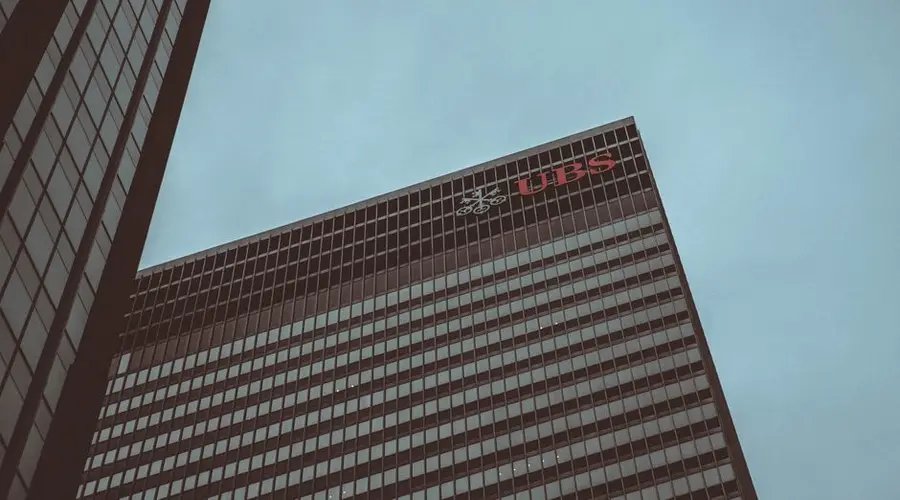 Modern skyscraper featuring the UBS logo against a clear sky in New York City.