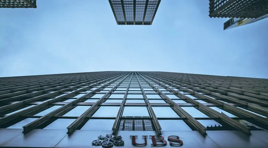 Low angle view of New York skyscrapers with UBS logo, emphasizing height and urban architecture.