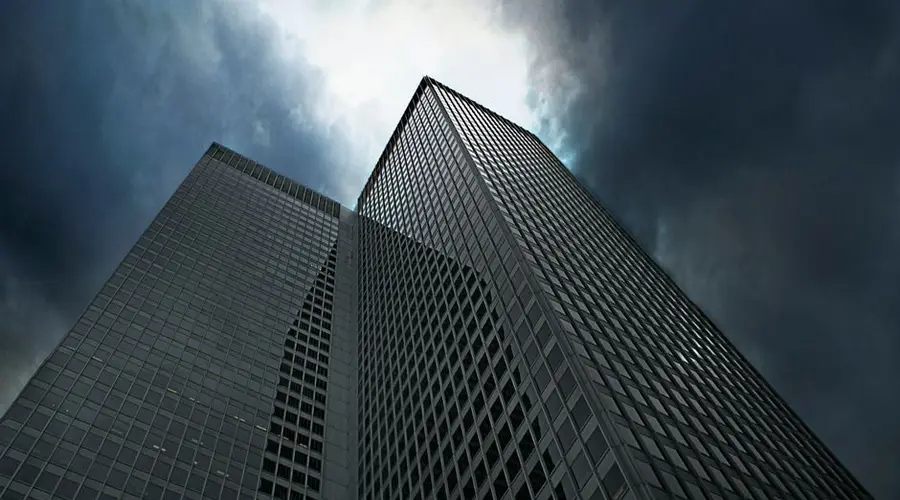 Dramatic view of towering skyscrapers in Montreal with ominous clouds overhead.