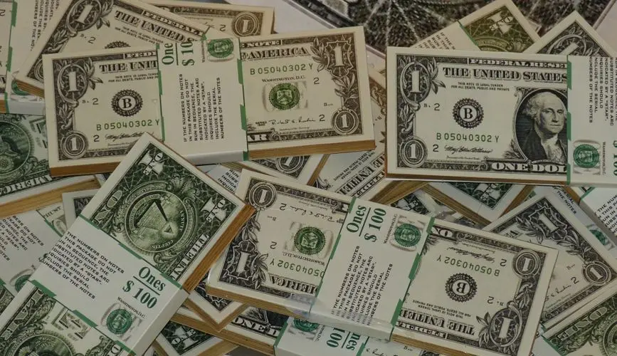 Numerous bundles of US one dollar bills symbolizing wealth, finance, and savings.