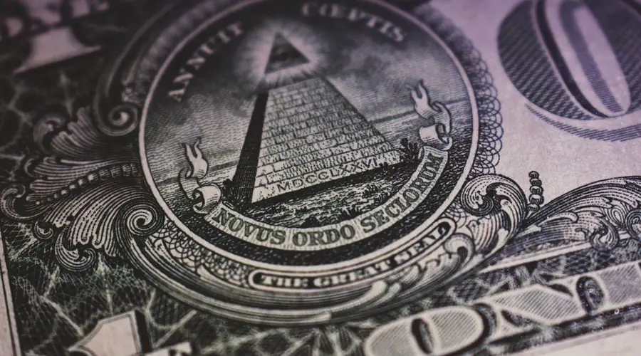 Detailed close-up of US dollar bill showing the Eye of Providence and pyramid design.