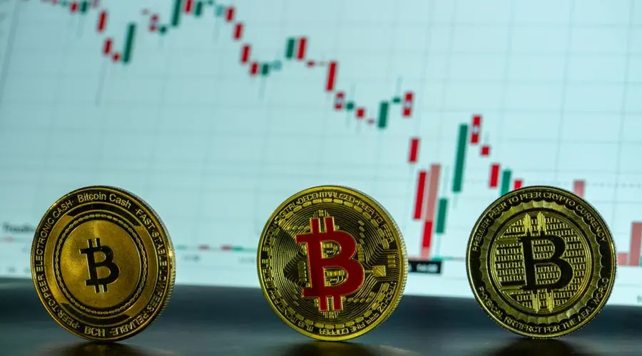 Bitcoin coins displayed in front of a financial market graph, illustrating cryptocurrency trends.