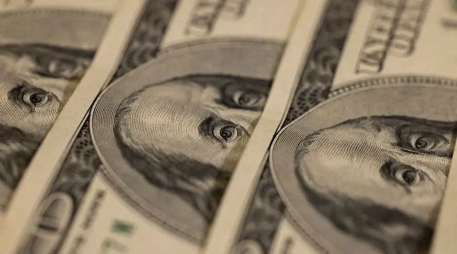 Detailed macro shot of multiple US dollar bills showcasing intricate currency design.