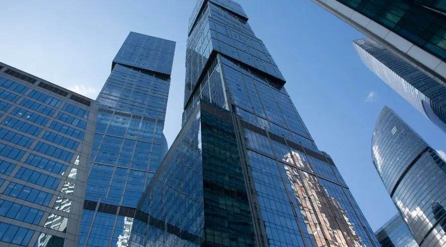 Dynamic view of Moscow's striking modern skyscrapers under a clear blue sky.