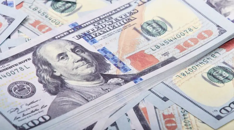Detailed close-up of United States 100 dollar bills emphasizing currency and finance.