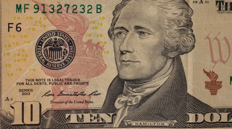 Detailed close-up image of a US ten dollar bill with Alexander Hamilton's portrait.