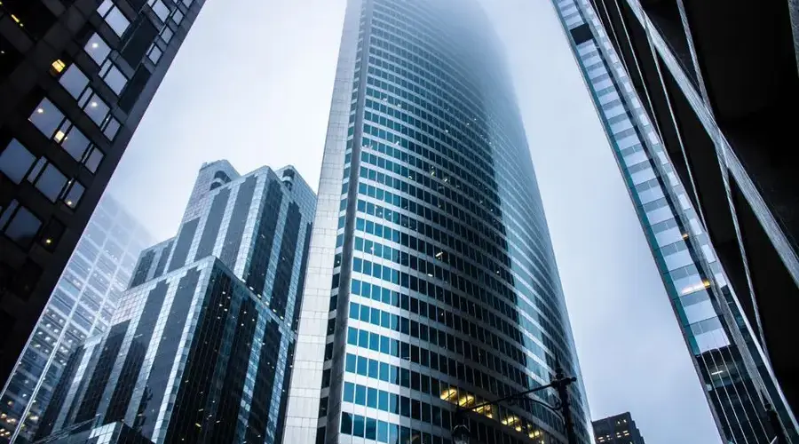 Dramatic view of modern skyscrapers shrouded in fog in an urban cityscape.