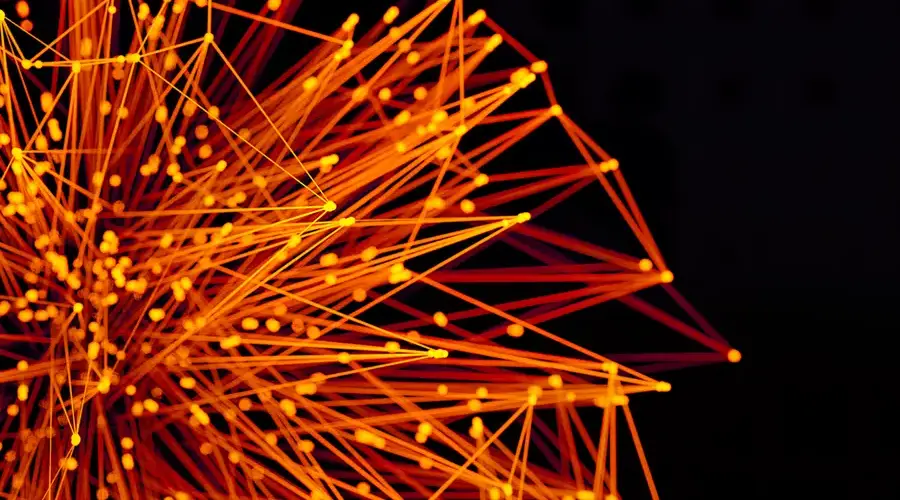 Vibrant orange lines and dots form an abstract network on a dark background, evoking technology and connectivity.
