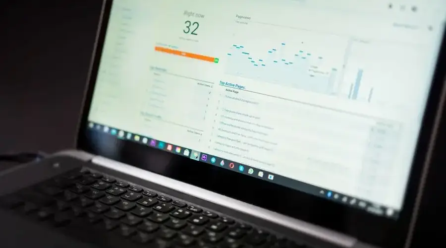 A laptop displaying an analytics dashboard with real-time data tracking and analysis tools.