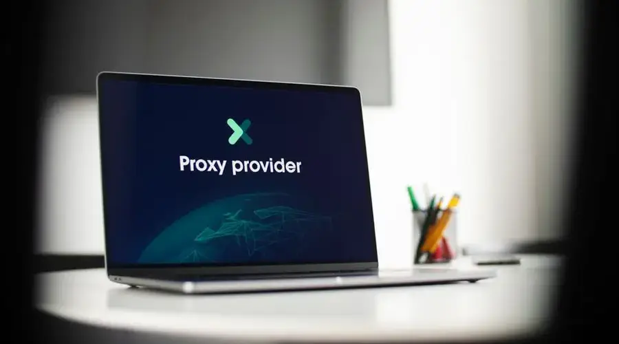 Laptop screen showing 'Proxy provider' in a tech office setting, focus on cybersecurity.