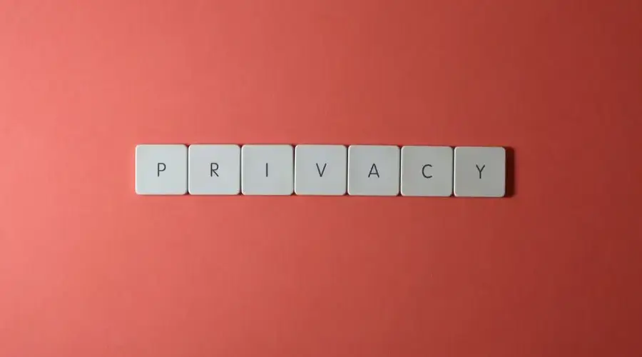 Close-up of letter tiles spelling PRIVACY on a red background, symbolizing data protection.