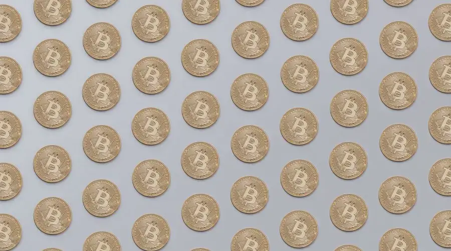 High-resolution image of golden Bitcoin coins arranged in a seamless pattern, ideal for financial or technological themes.