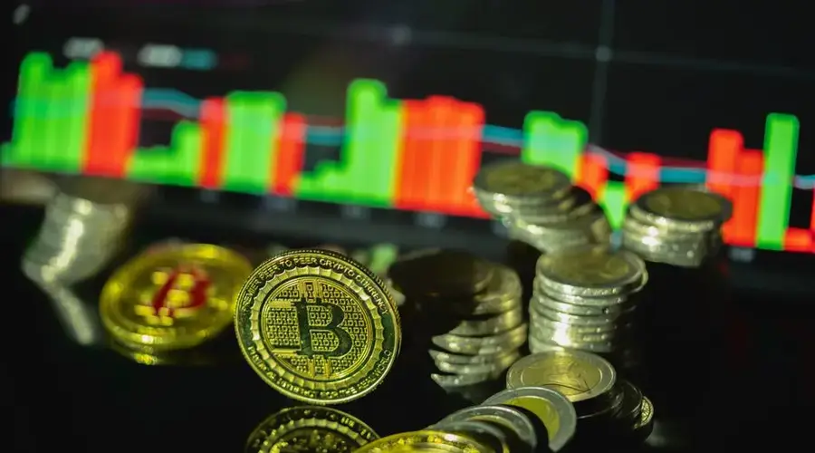 Golden Bitcoin coins in focus with a vibrant financial chart display in the background.