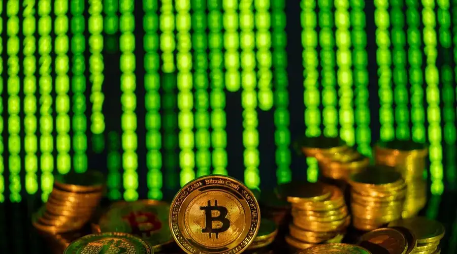Stacks of golden bitcoins in front of a digital matrix, symbolizing cryptocurrency and blockchain technology.