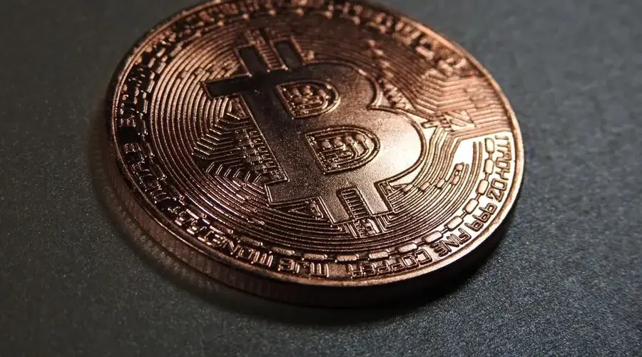 High-resolution close-up of a copper Bitcoin coin symbolizing digital currency and investment.