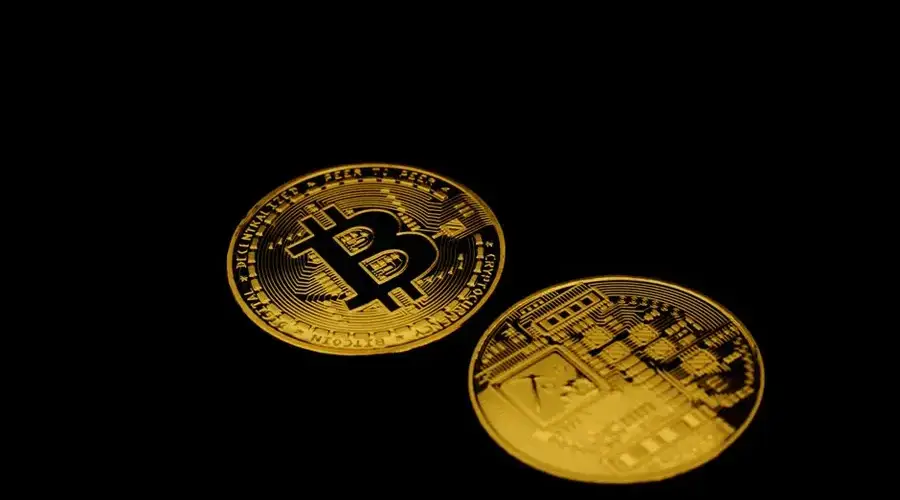 Golden Bitcoin cryptocurrency coins on a dark background symbolizing digital finance and investment.