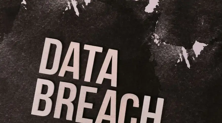 A conceptual image highlighting the issue of data breaches, featuring bold text on a textured background.