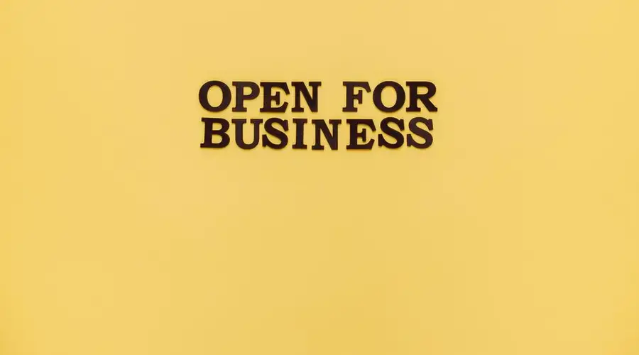Bold 'Open for Business' text on a vibrant yellow background for advertising.