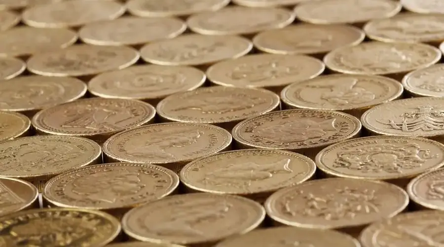 Detailed image of stacked gold coins, symbolizing wealth and savings.