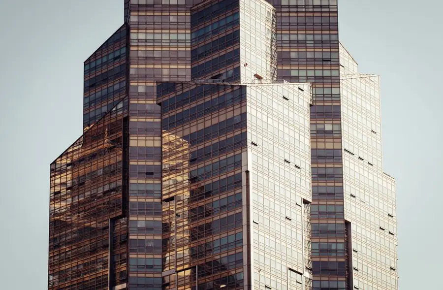 A modern skyscraper with a reflective glass facade capturing the urban architectural style.