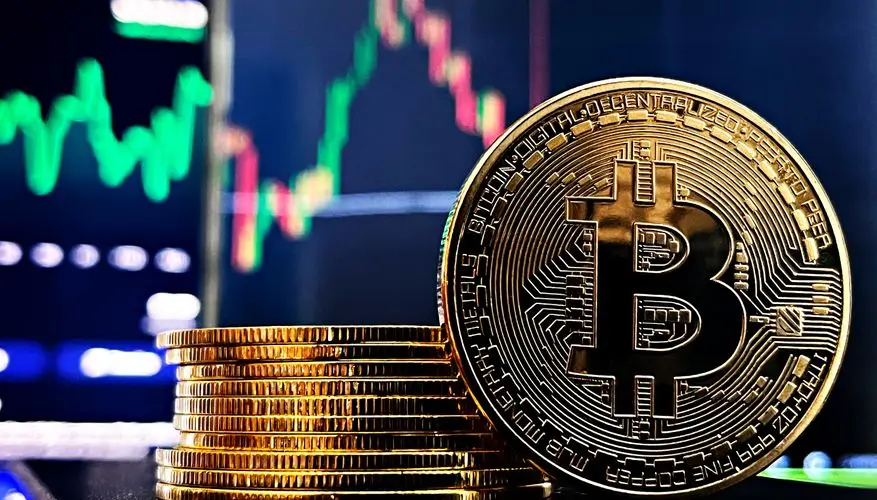 Gold Bitcoin with financial market charts in the background, symbolizing cryptocurrency trading.