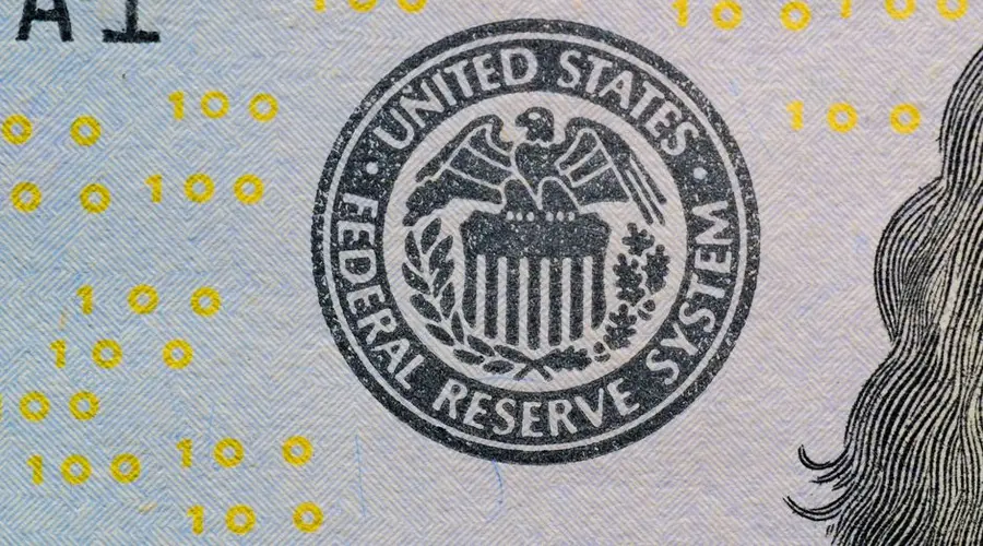 Detailed view of the US Federal Reserve System seal on currency with yellow digital numbers.
