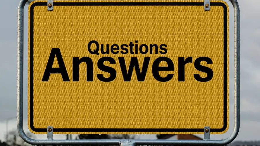 Yellow sign with text questions and answers suggesting direction in decision-making.