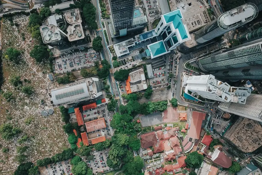 Drone view of big city district with glass skyscrapers and urban contemporary buildings