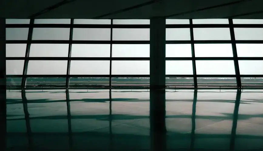Spacious airport terminal window reflections create a geometric and architectural effect.
