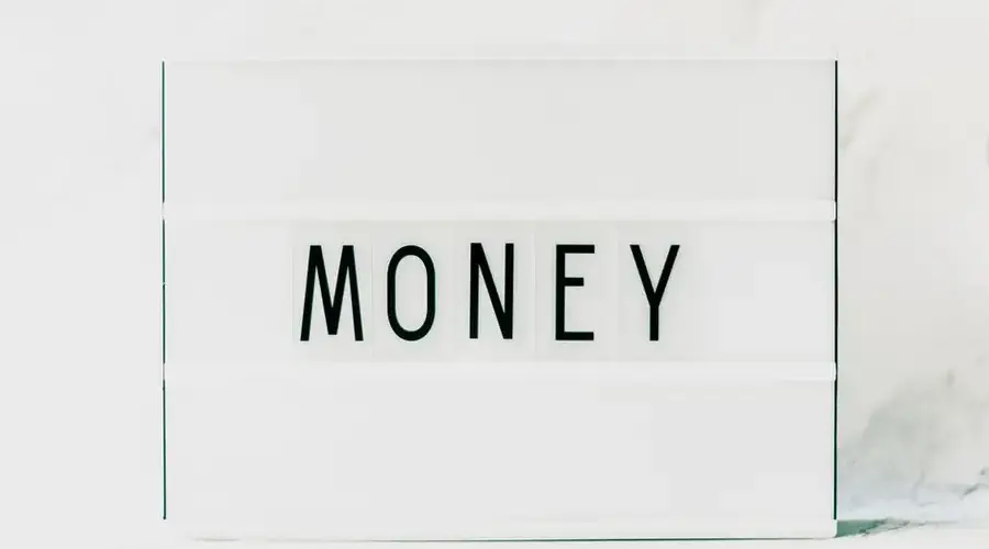 Contemporary minimalist lightbox displaying the word 'Money' on a clean white background.