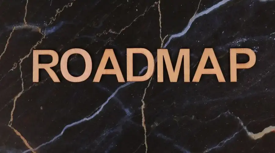 Wooden letters spelling ROADMAP on a dark marble surface, ideal for business presentations.