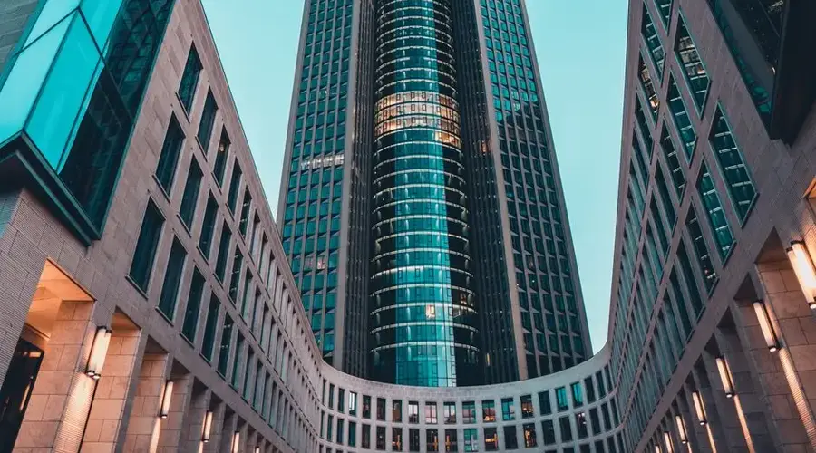 Contemporary urban skyscraper showcases sleek geometric architecture in cityscape.