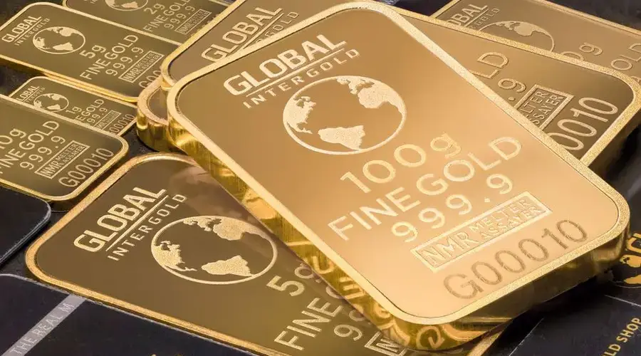 A detailed shot of gold bars labeled 'Global Intergold' as a symbol of wealth and investment.