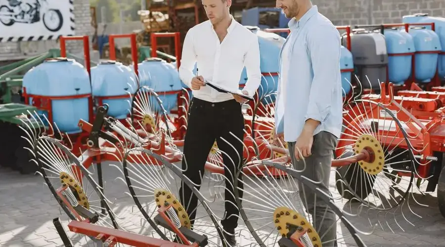Two men discussing farm equipment at an outdoor agricultural machinery supplier.