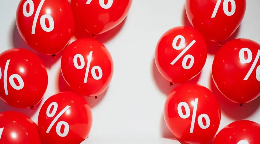 Red balloons with percentage signs, ideal for marketing promotions and sales events.